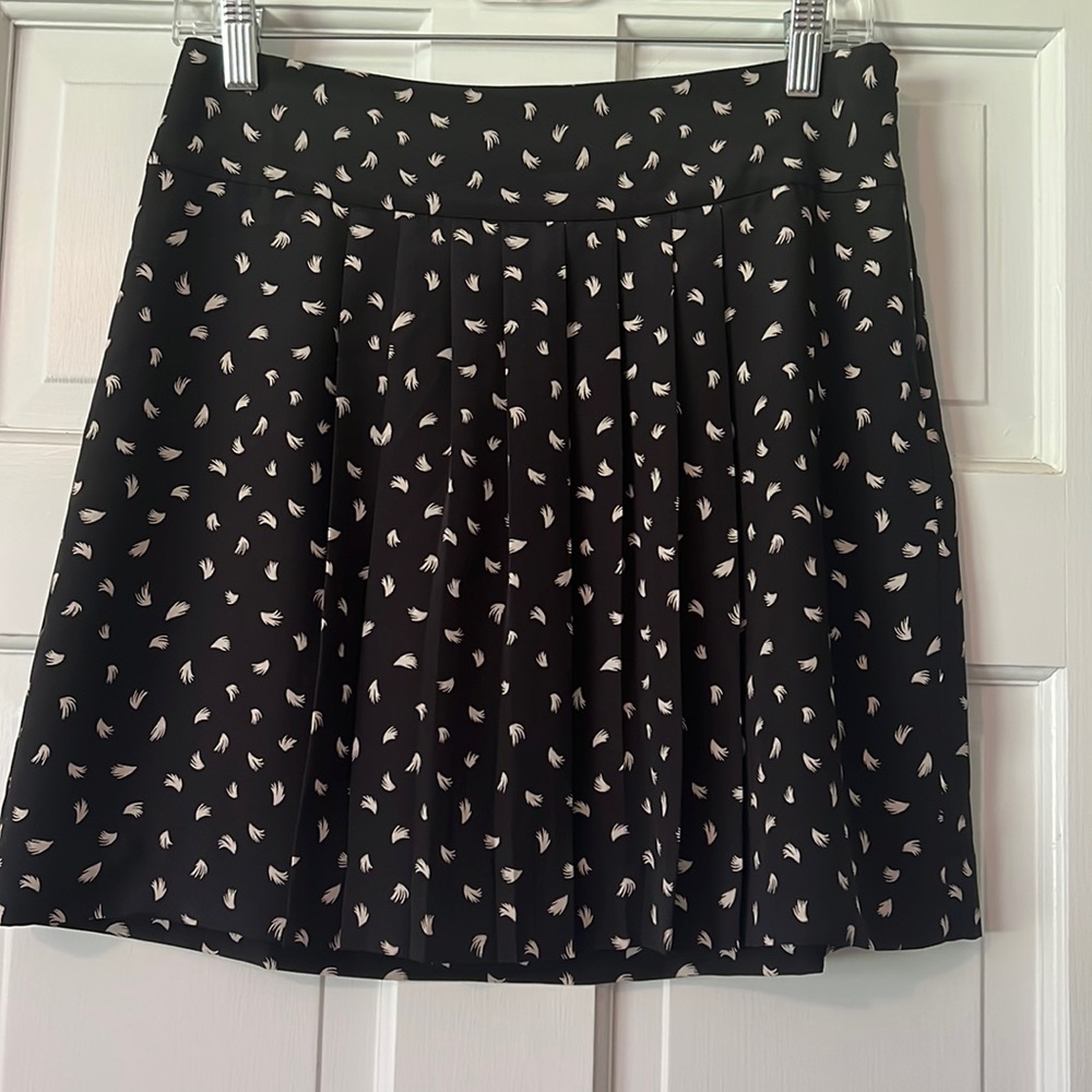 LOFT 2 petite black skirt with zipper on side. Feather pattern in off-white.